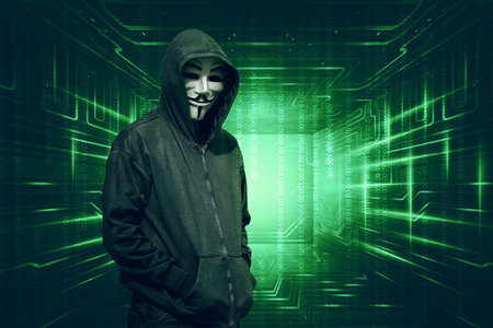 Hooded with anonymous mask standing with binary code on backgroundのeditorial素材