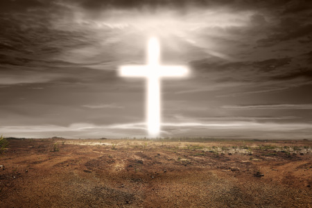 Bright shaped cross on the sky in dry landの写真素材