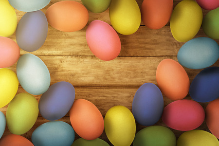 Colorful easter eggs on wooden floor background with spaceの写真素材