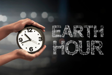 Turn off the light in 60 minute with Earth Hour message on blurred light backgroundの写真素材