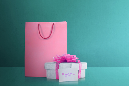 Shopping bag with gift box with pink ribbon for mom. Mother's Day Concept.の写真素材