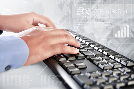 Businessman is typing on keyboard with interface virtual graph on backgroundの写真素材