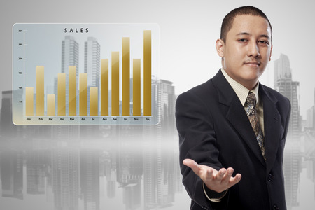 Asian businessman with chart sales offering to shake the hand in cityscape backgroundの写真素材