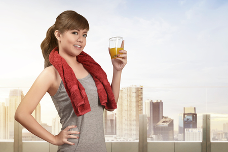 Smiling asian woman drinking a healthy natural juice for healthy diet conceptの写真素材