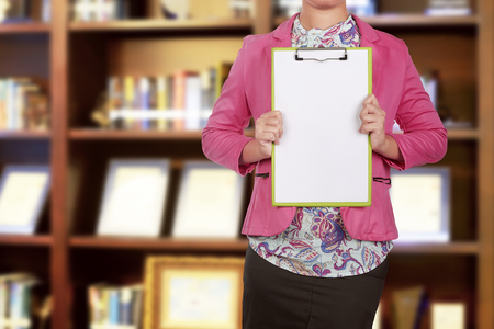 Business people holding blank clipboard for copyspace on the officeの写真素材