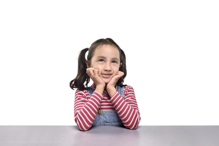 Portrait of asian girl thinking with head lean back on hand isolated over white backgroundの写真素材