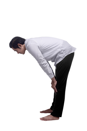 Young asian muslim man is praying isolated over white backgroundの写真素材