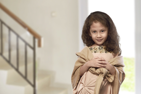 Asian muslim kid with traditional dress in the homeの写真素材