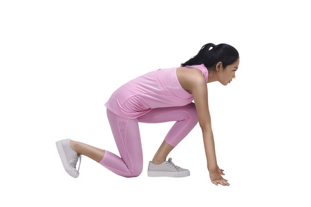 Young asian woman athlete ready to running workout isolated over white backgroundの写真素材