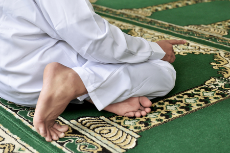Portrait of muslim man praying to god inside the mosqueの写真素材