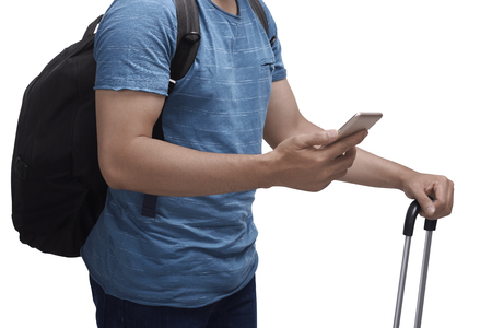 Man holding cellphone and suitcase. Travel concept imageの写真素材