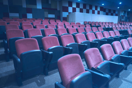 Row of seats with black armchairs in the cinema