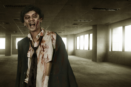 Creepy asian zombies man with blood on old roomの写真素材