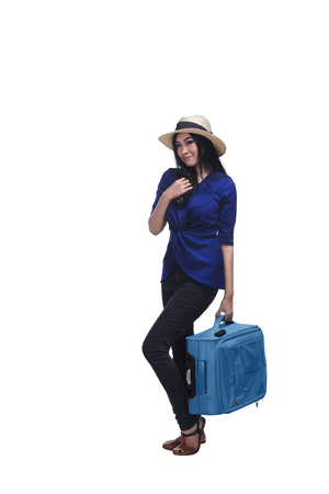 Beautiful asian woman standing with suitcase isolated over white backgroundの写真素材
