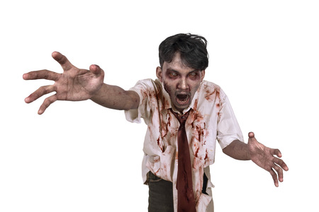 Horrible scary zombie in clothes want to catch you isolated over white backgroundの写真素材