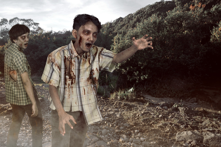 Two asian zombies with wounded face walking outdoorsの写真素材