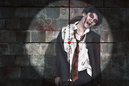 Weapon aiming to shooting bloody asian zombie man over black wall backgroundの写真素材