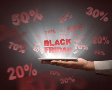 People holding tablet and showing special sale on Black Friday over black backgroundの写真素材