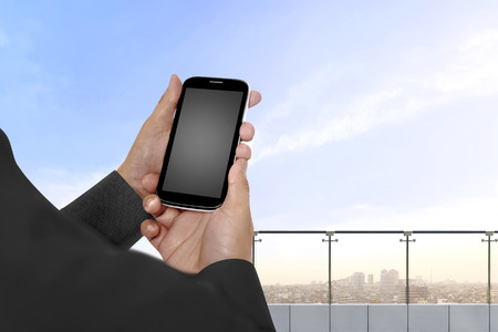 Hand holding cellphone with empty blank screen for copyspaceの写真素材