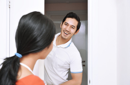 Young asian couple with smile having fun together at homeの写真素材