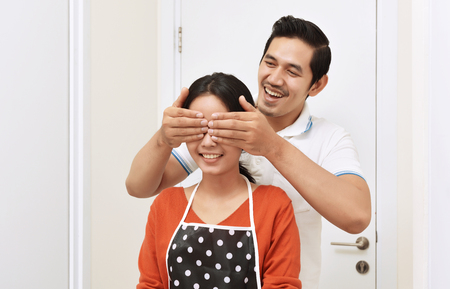 Young asian couple with smile having fun together at homeの写真素材