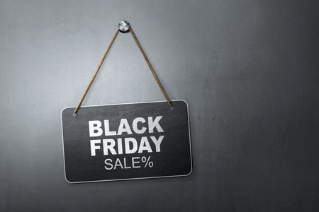 Black Friday Discount Sale message written on hanging blackboard with dark wall backgroundの写真素材