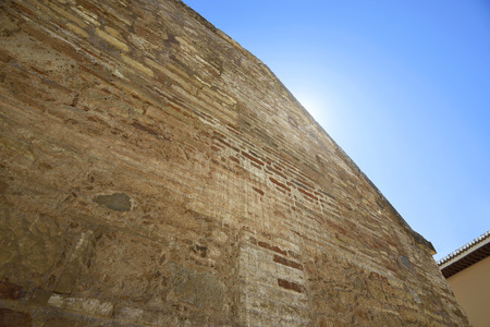 View of Old brick wall texture of a residential building against blue sky backgroundの写真素材