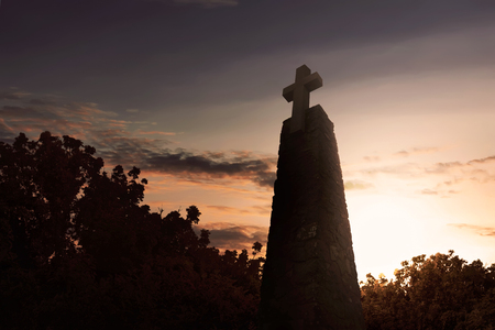 Monument with large cross against dramatic sky backgroundの写真素材