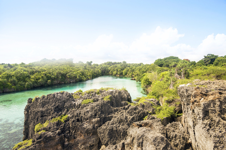 Scenery of natural lake with surrounded by cliffs on Weekuri, Sumba, Indonesiaの写真素材