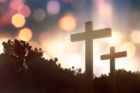 Christian cross on the field with bokeh backgroundの写真素材