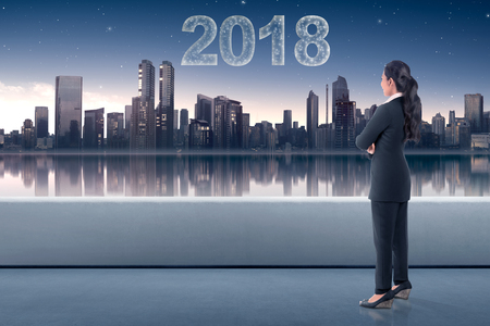 Young asian business woman looking at the city with star make 2018 shape on the skyの写真素材