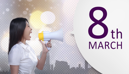 Beautiful asian business woman with megaphone announce 8 March is International Women's Dayの写真素材