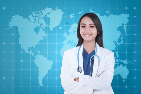 Pretty asian doctor woman in white uniform with stethoscope on modern background の写真素材