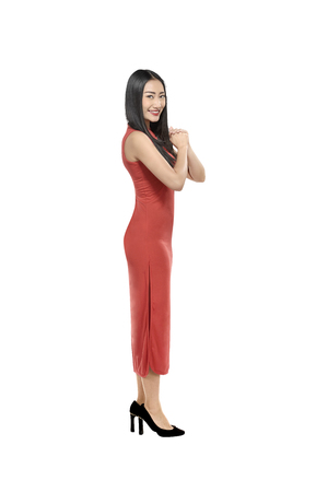 Portrait of chinese woman in cheongsam dress with gesture of congratulation isolated over white backgroundの写真素材