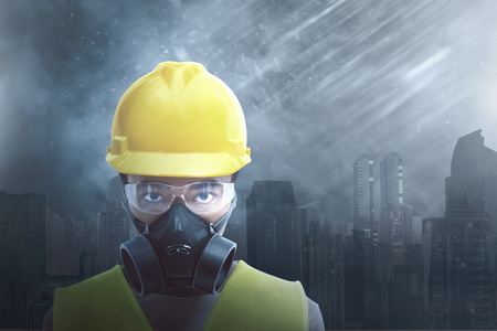 Attractive asian construction worker wearing safety protection with cityscape backgroundの写真素材