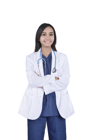 Portrait of Asian female doctor in white coat and stethoscope posing isolated over white backgroundの写真素材