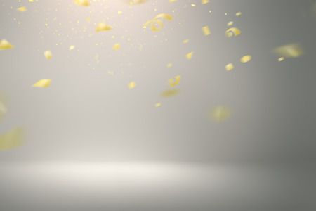Falling gold confetti on grey backgroundの写真素材