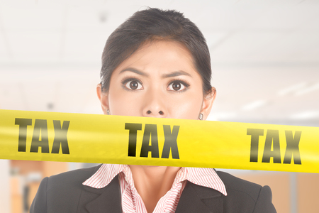 Image of asian business woman shock about taxの写真素材