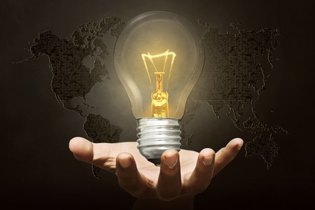 Human hand holding glowing lights bulb. Earth Hour Conceptの写真素材