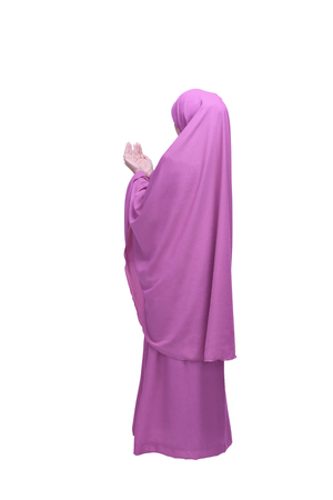 Portrait of asian muslim woman praying to god posing isolated over white backgroundの写真素材