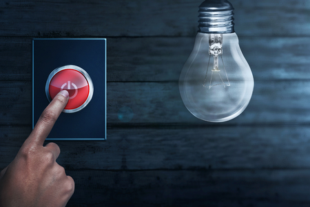 People hands turning off bulb light. Earth Hour Conceptの写真素材