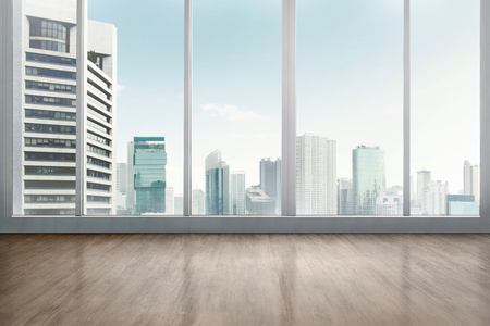 Empty office room with wooden floor with cityscape backgroundの写真素材