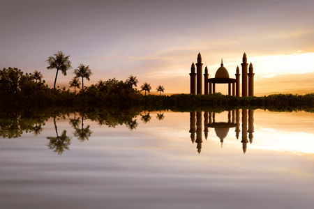 Reflection of beautiful mosque on the water during sunsetの写真素材