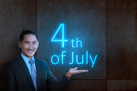 Young asian businessman showing glowing light of 4th of July. Independence day 4th of Julyの写真素材