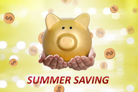 People hands holding piggy bank. Summer saving conceptの写真素材
