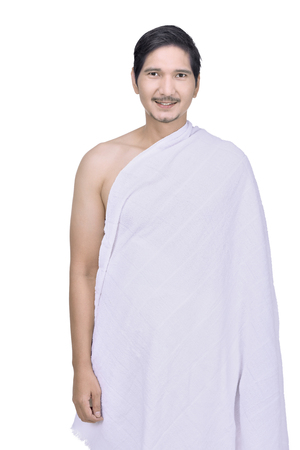 Portrait of asian muslim man wearing ihram clothes isolated over white backgroundの写真素材