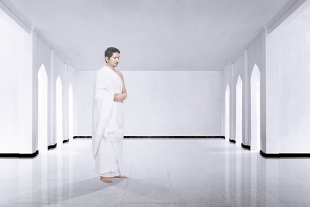 Photo of asian muslim man with ihram cloth praying inside the mosqueの写真素材