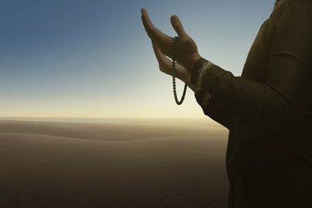 Muslim man pray to god with blue sky backgroundの写真素材