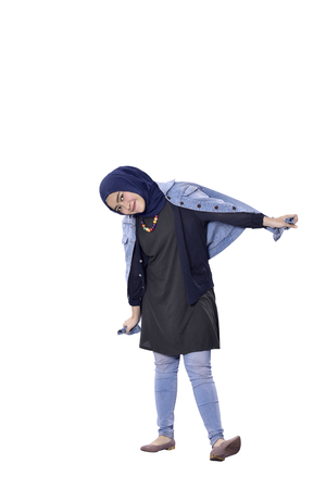 Cheerful asian muslim woman with happy expression isolated over white backgroundの写真素材