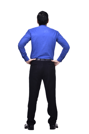 Portrait of asian businessman with hands on waist looking up at something isolated over white backgroundの写真素材
